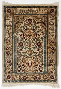 A Hereke silk rug, c. 73 x 52 cm.