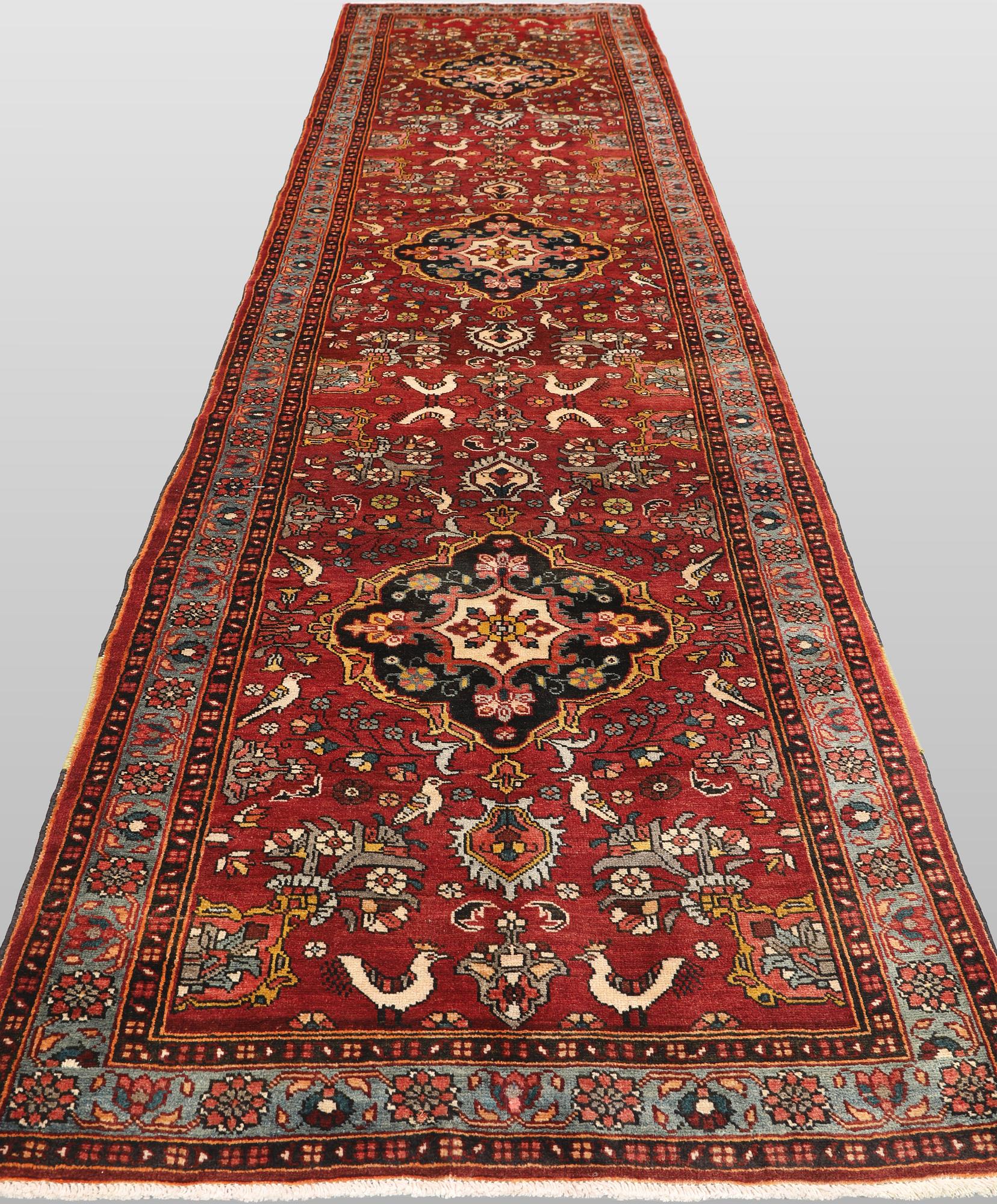 A figural Hamadan runner carpet, 450 x 112 cm.