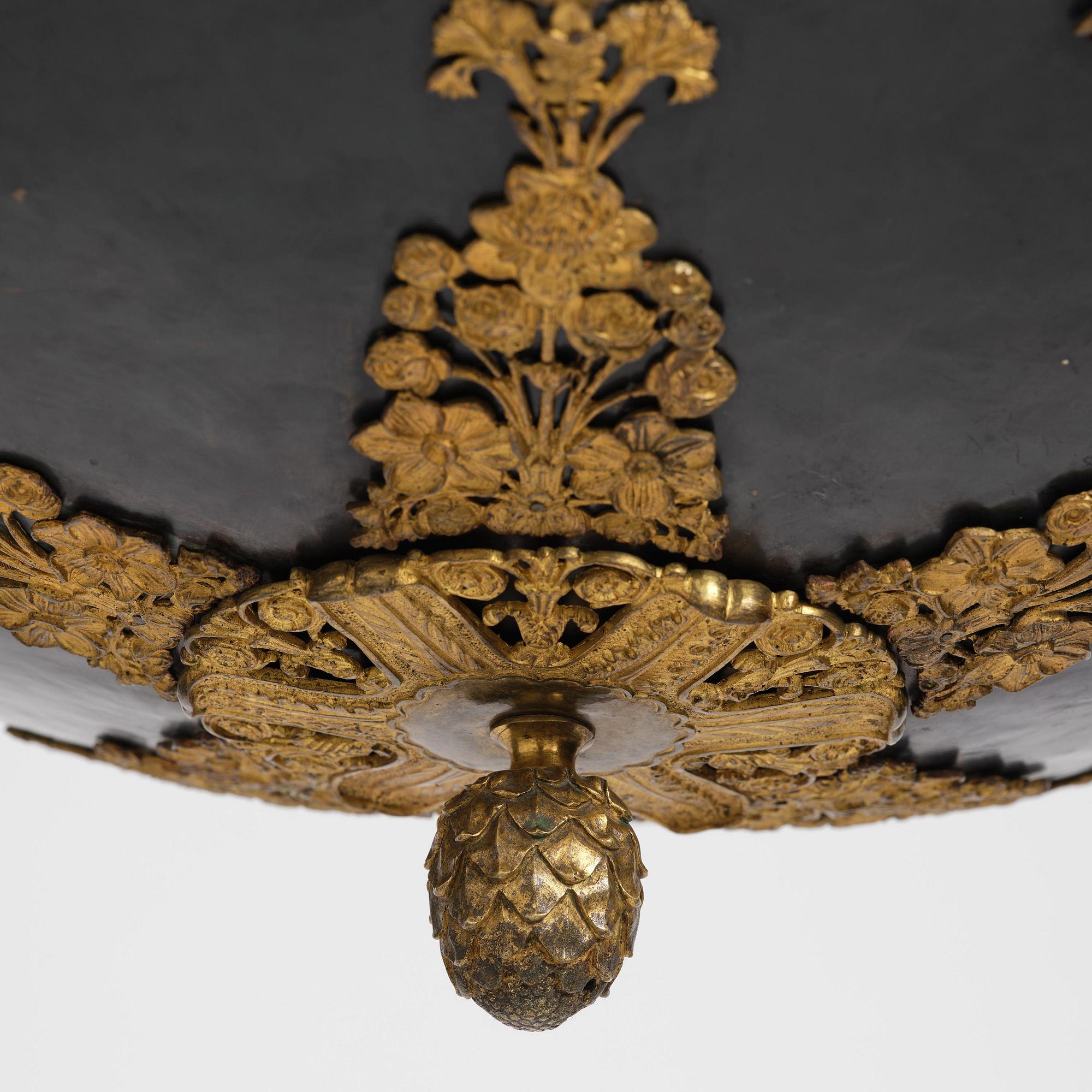 A presumably Russian Empire gilt and patinated bronze nine-branch chandelier, 19th century.