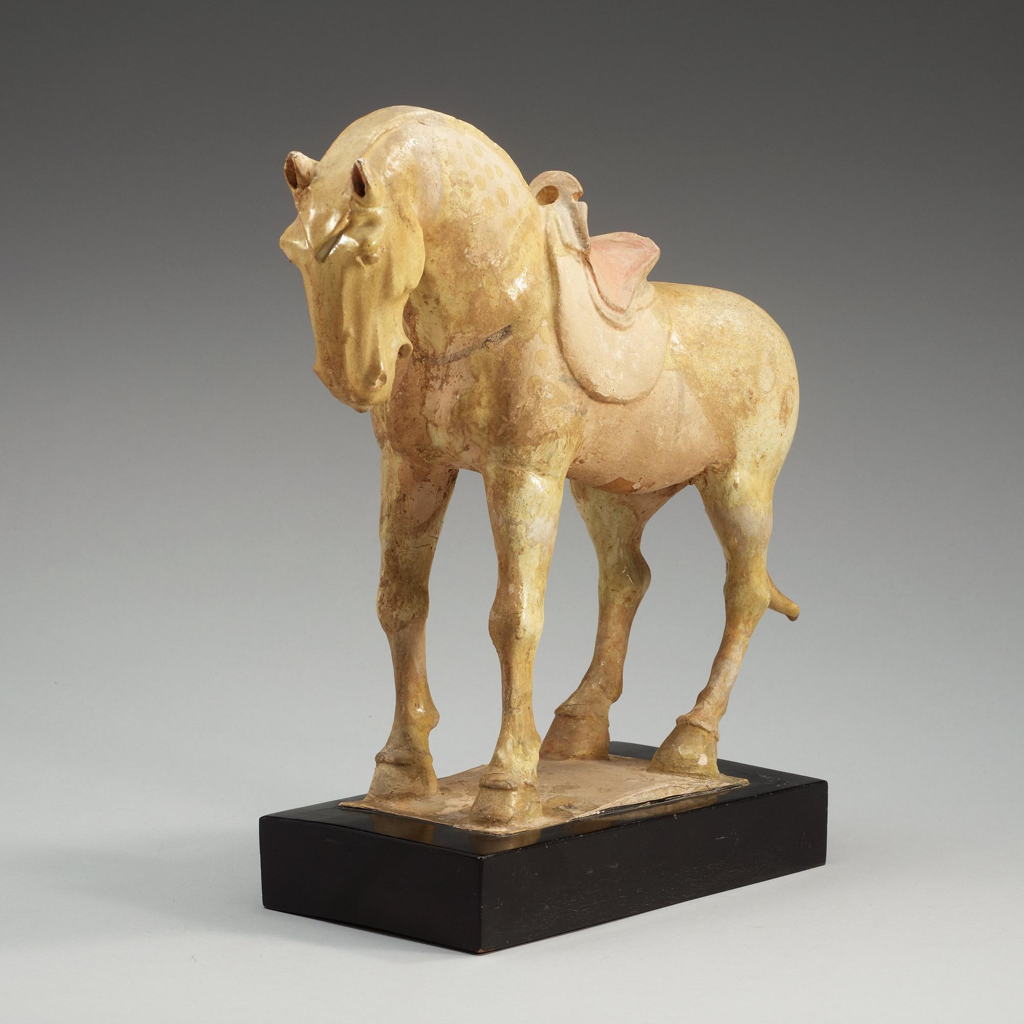 A yellow glazed pottery figure of a horze, presumably Tang dynasty (618-907).