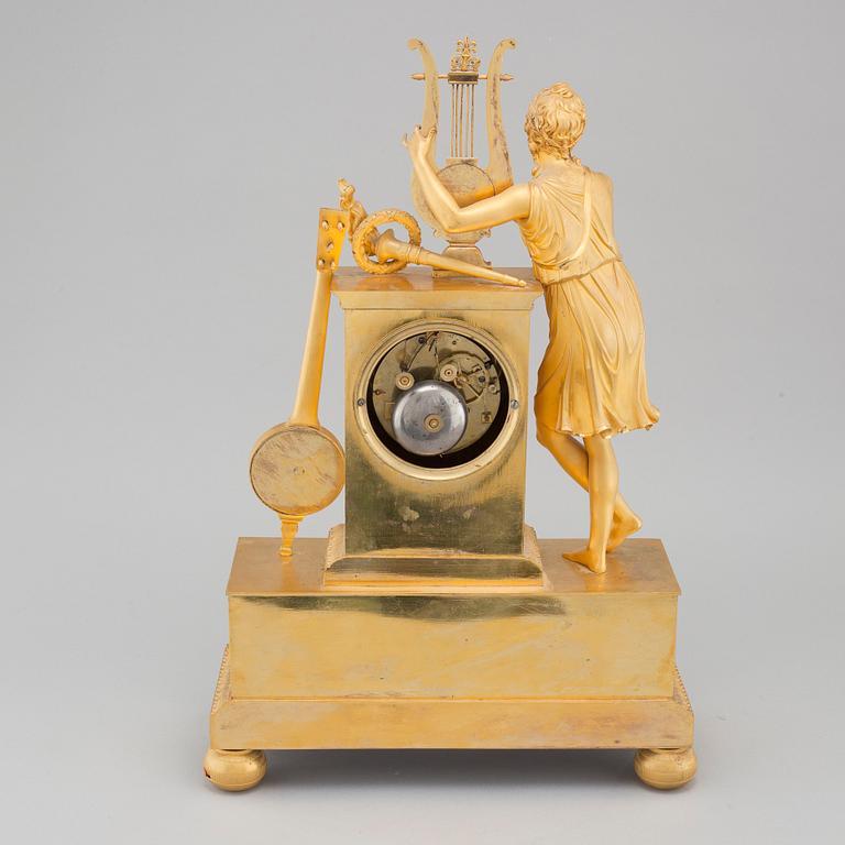 An Empire table clock, dial marked "L Ravrio Bronzier à Paris Mesnil H", fist half of the 20th century.