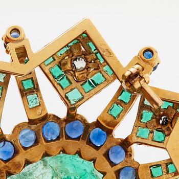 An 18K gold brooch set with an oval emerald and old cut diamonds.