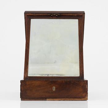 An early 19th century mahogny-veneered box for shaving utensils.