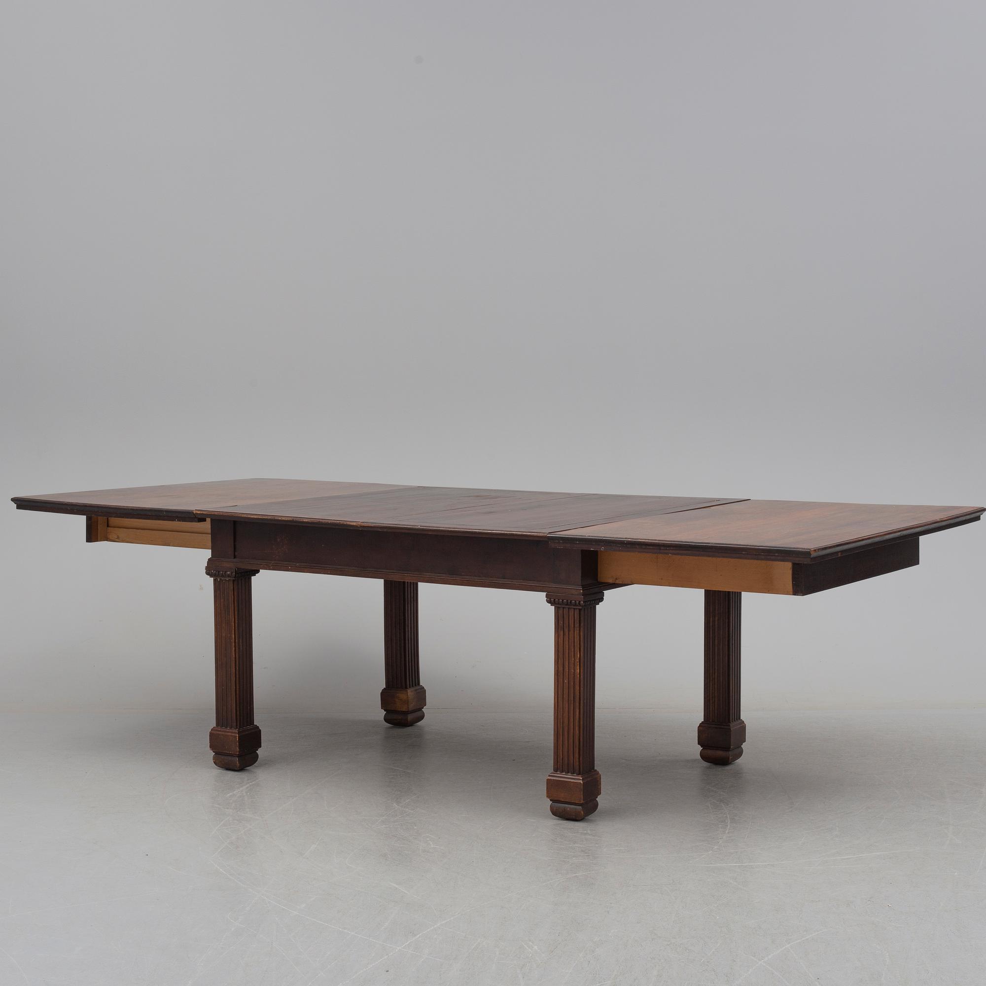 A 19th century dining table and a set of twelve chairs.