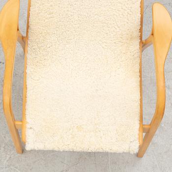 Yngve Ekström, a 'Lamino' armchair and ottoman, Swedese, 2002.