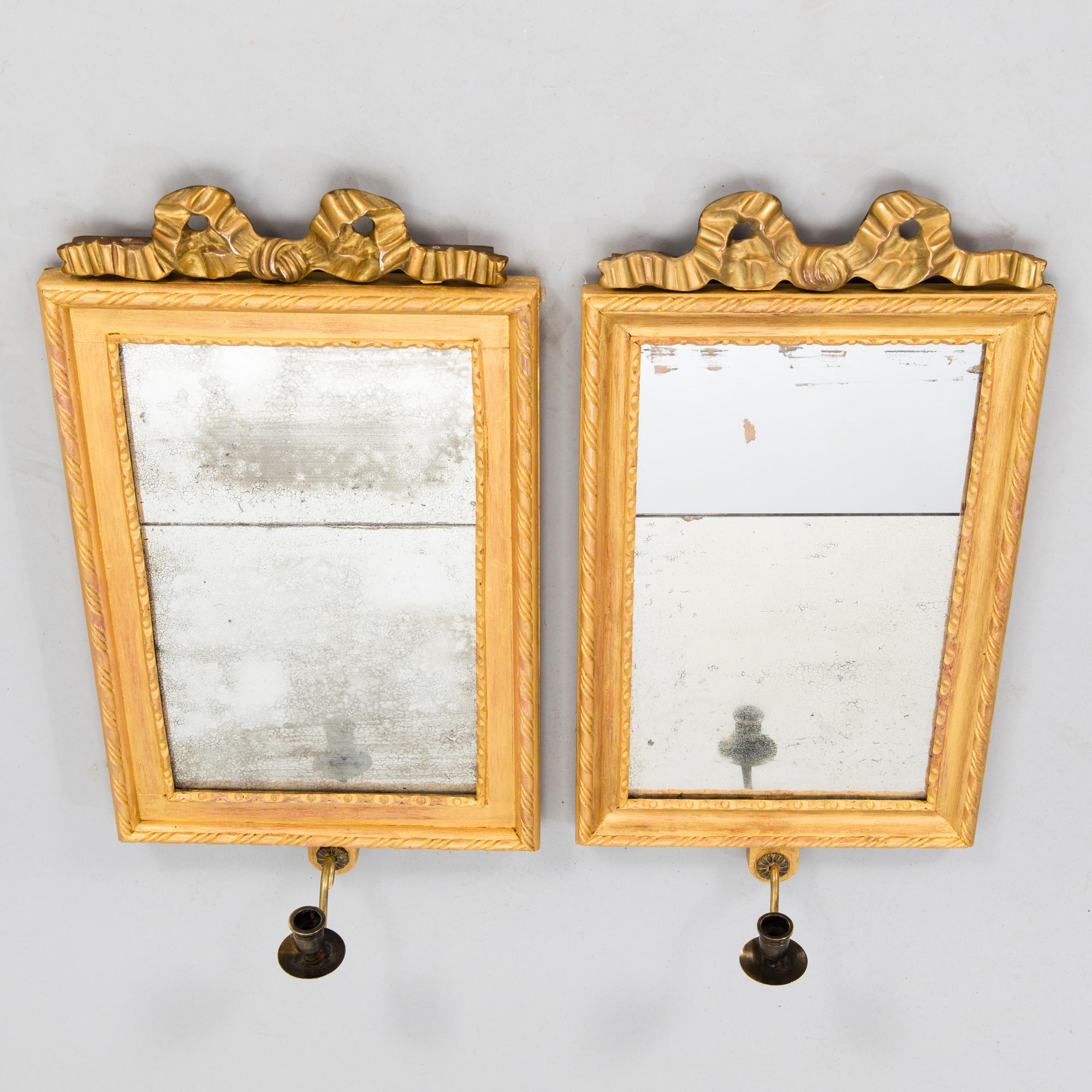 A pair of mirrored wall sconces from the latter half of the 20th century.