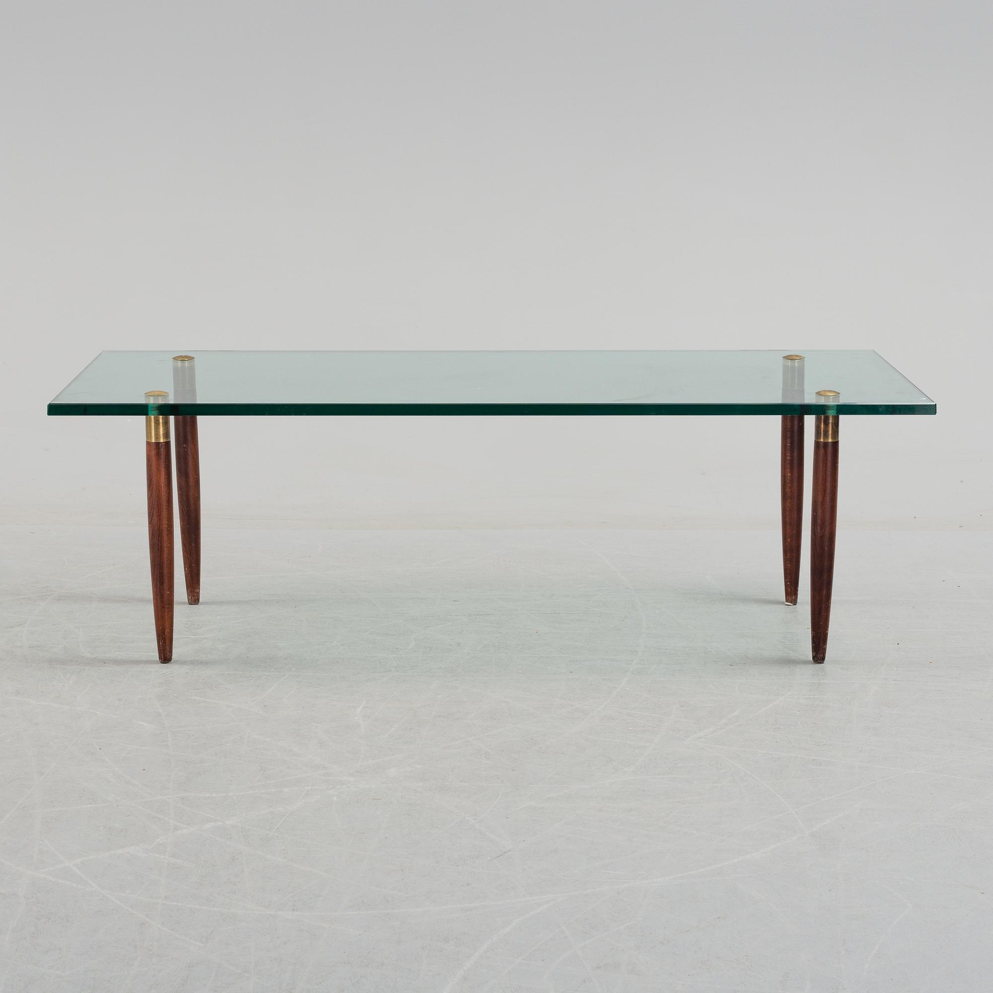 A 1960's glass sofa table.