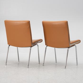 Hans J. Wegner, a pair pf "Kastrup Airport" lounge chairs, Denmark, late 20th century.
