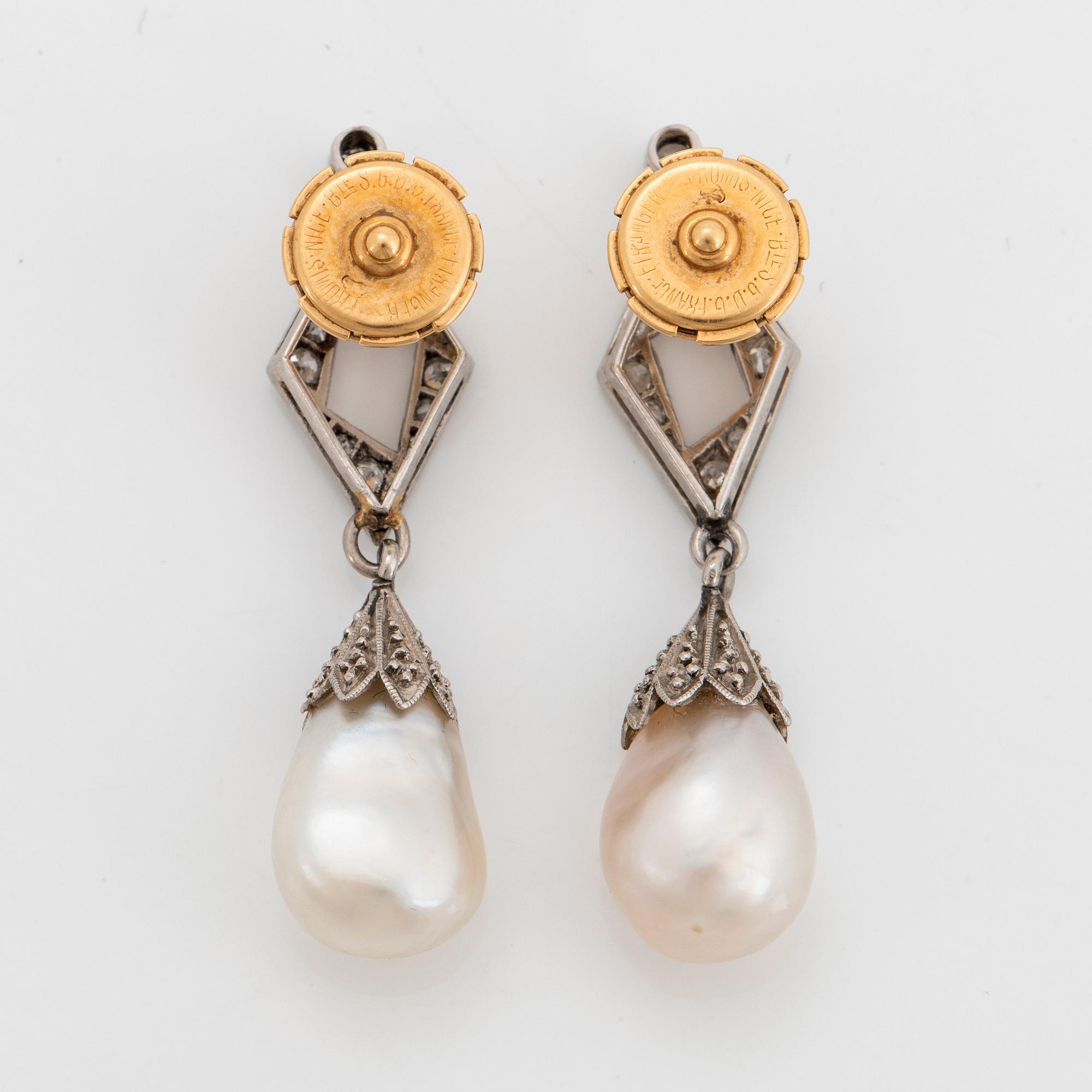 A pair of platinum and natural pearl earrings.