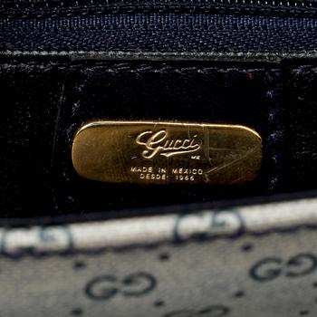 GUCCI, a coated blue monogram canvas shoulder bag.