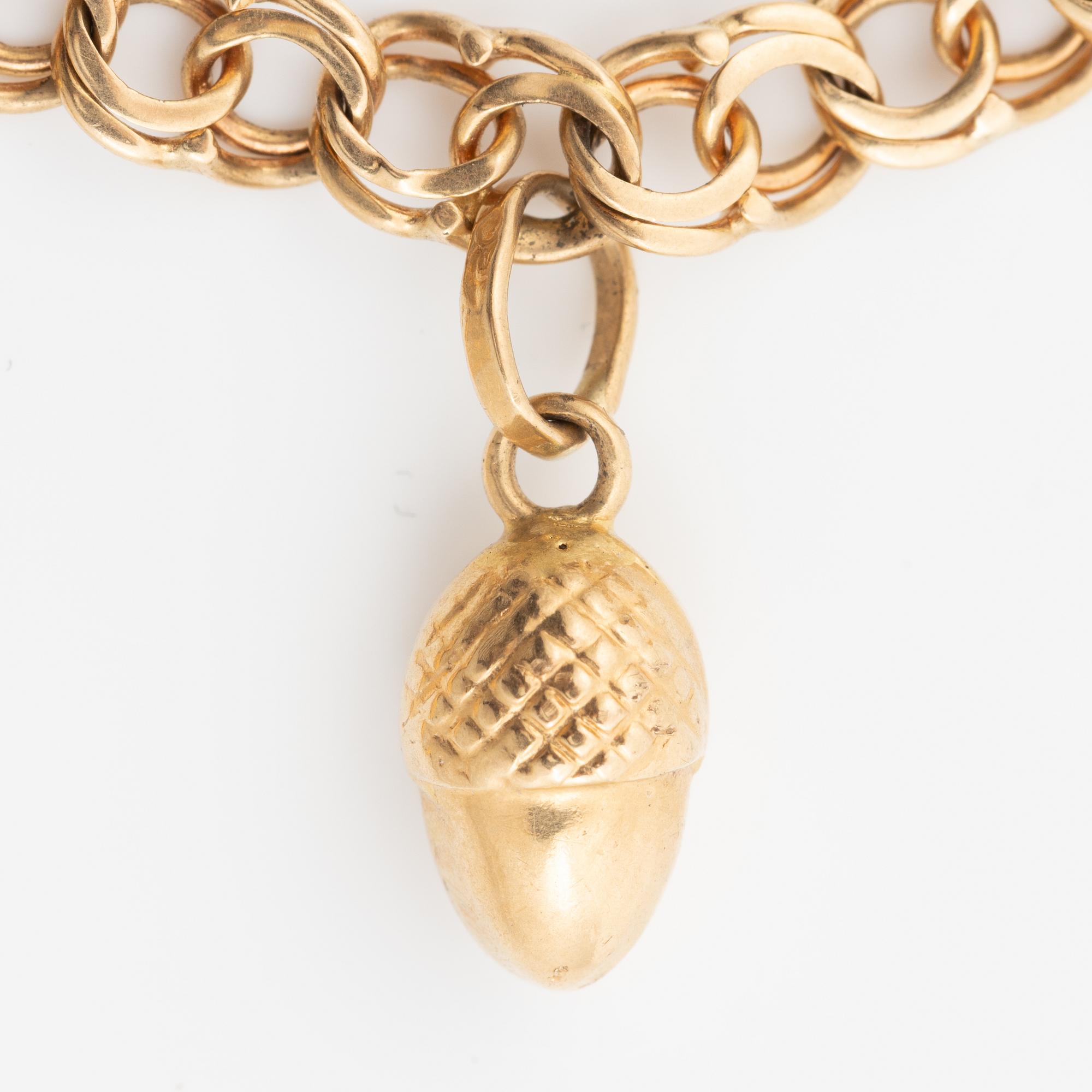 Bracelet, 18K gold bismarck link. With charms.
