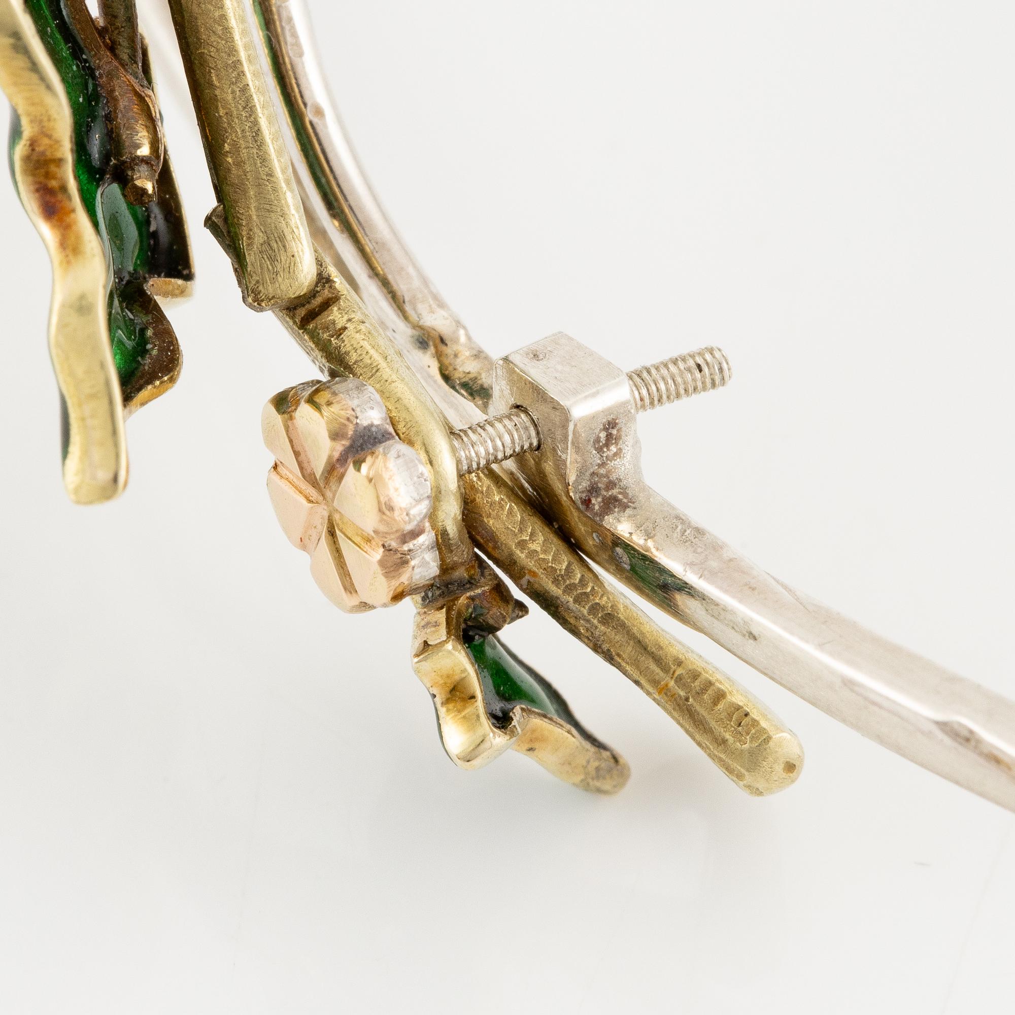 A necklace/tiara combination in 18K gold and green enamel set with old-cut diamonds.