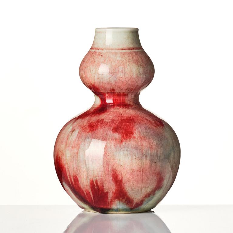 A Chinese peach bloom double gourd vase, Qing dynasty.