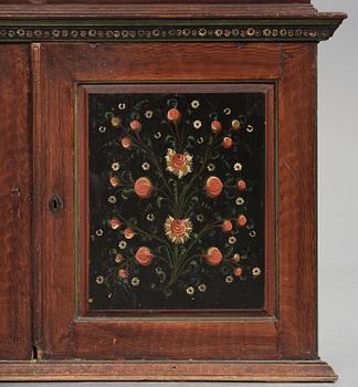 A Swedish polychrome painted folk art corner cabinet, dated 1818.