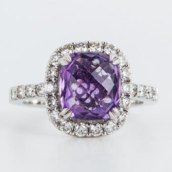 Brilliant-cut diamond and checker-cut amethyst ring.