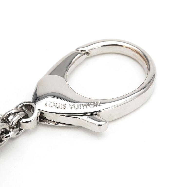LOUIS VUITTON, a palladium finished brass and white bag charm, "Fleur d'epi".
