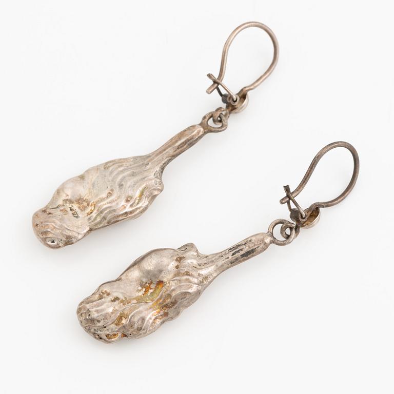 A pair of silver earrings, likely Olle Ohlsson.