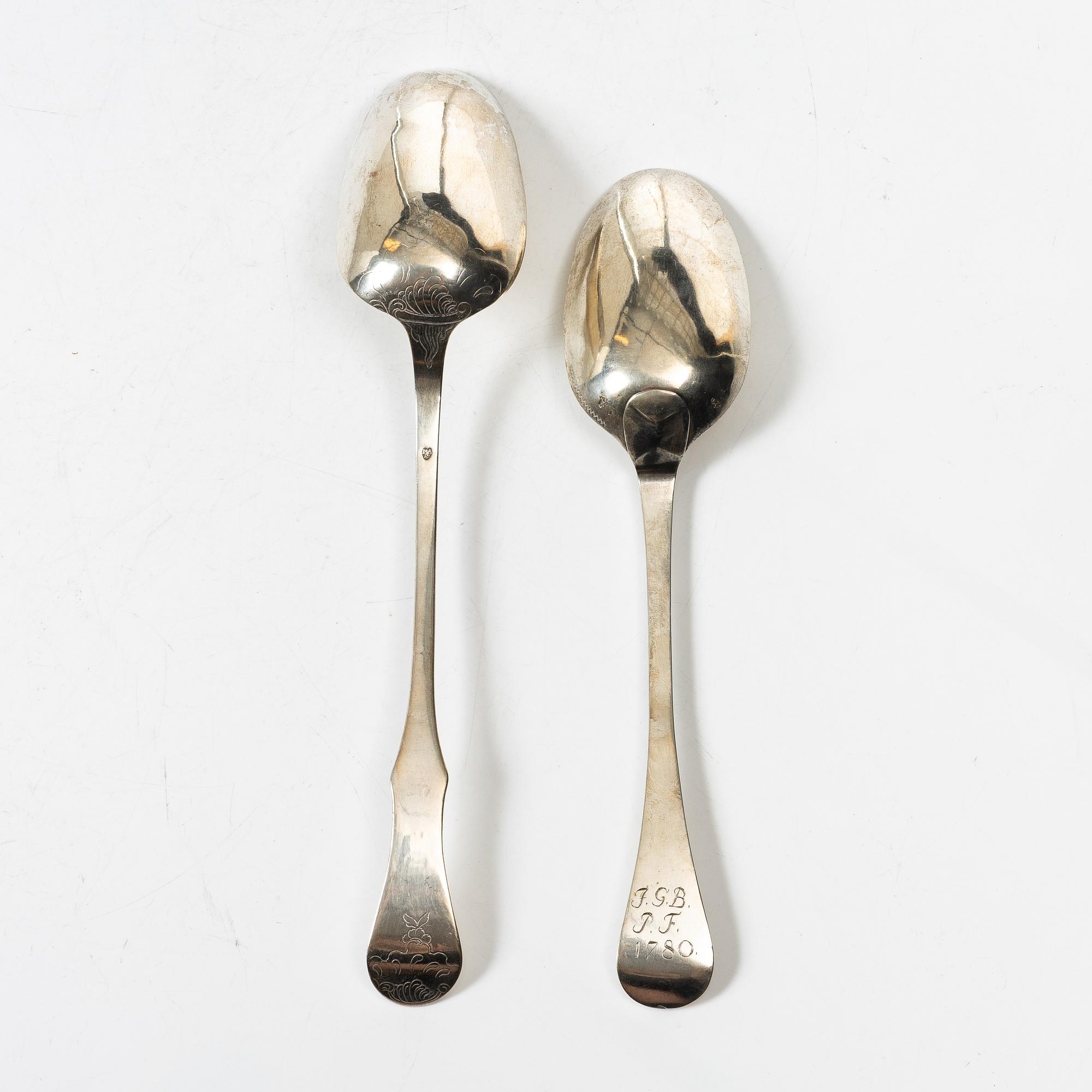 Two silver serving spoons with pseudo-marks, around the year 1900.