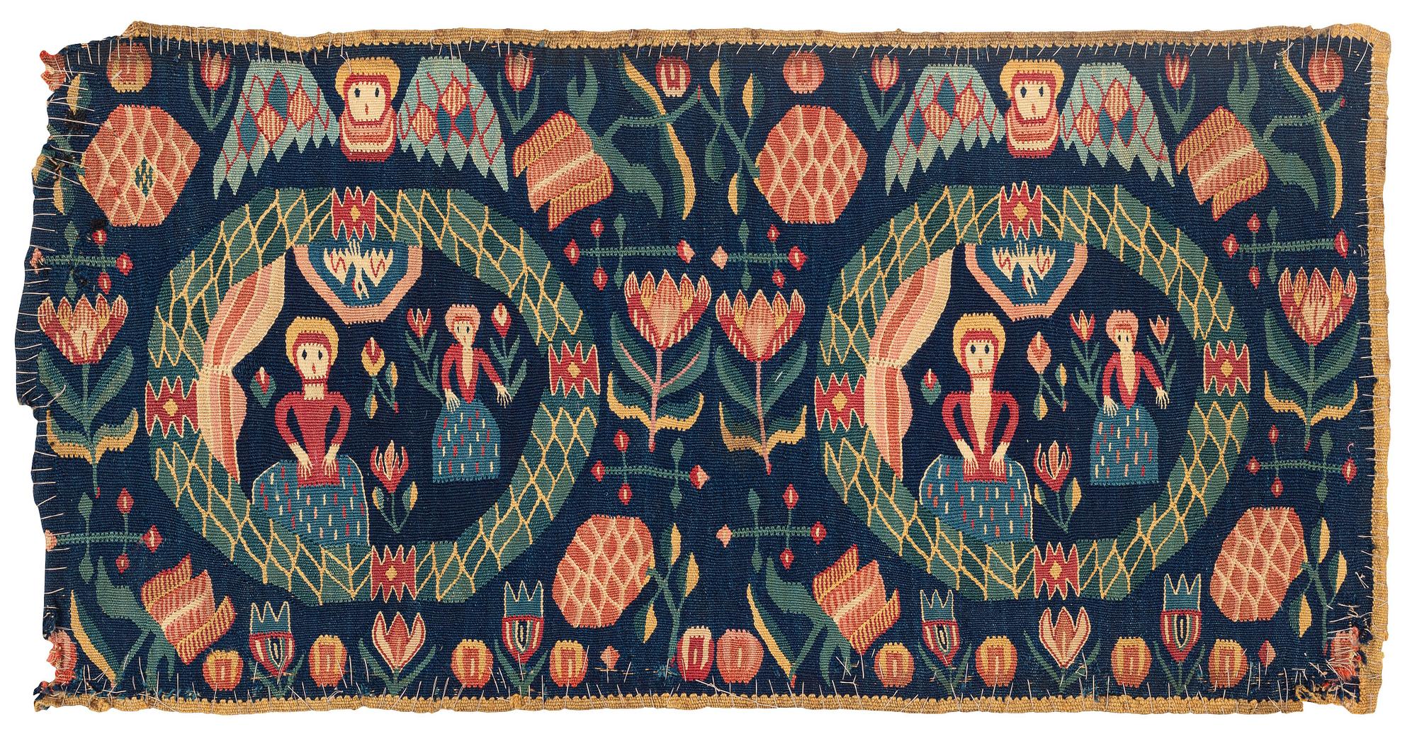 A carrige cushion, "Bebådelsen", tapestry weave, ca 95 x 47,5 cm, Skåne, 1800-1830.