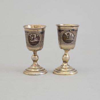 A pair of Russian 19th century parcel-gilt niello footed vodka cups, makers mark cyrillic "МД" (MD).