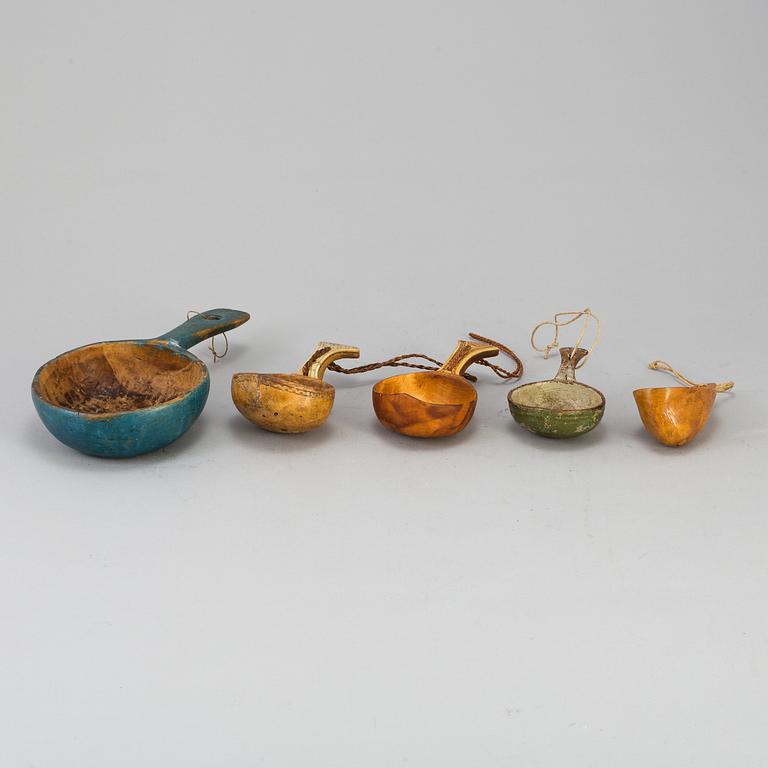 A set of five amongst others Sami cups made of birchwood and reindeer antlers.
