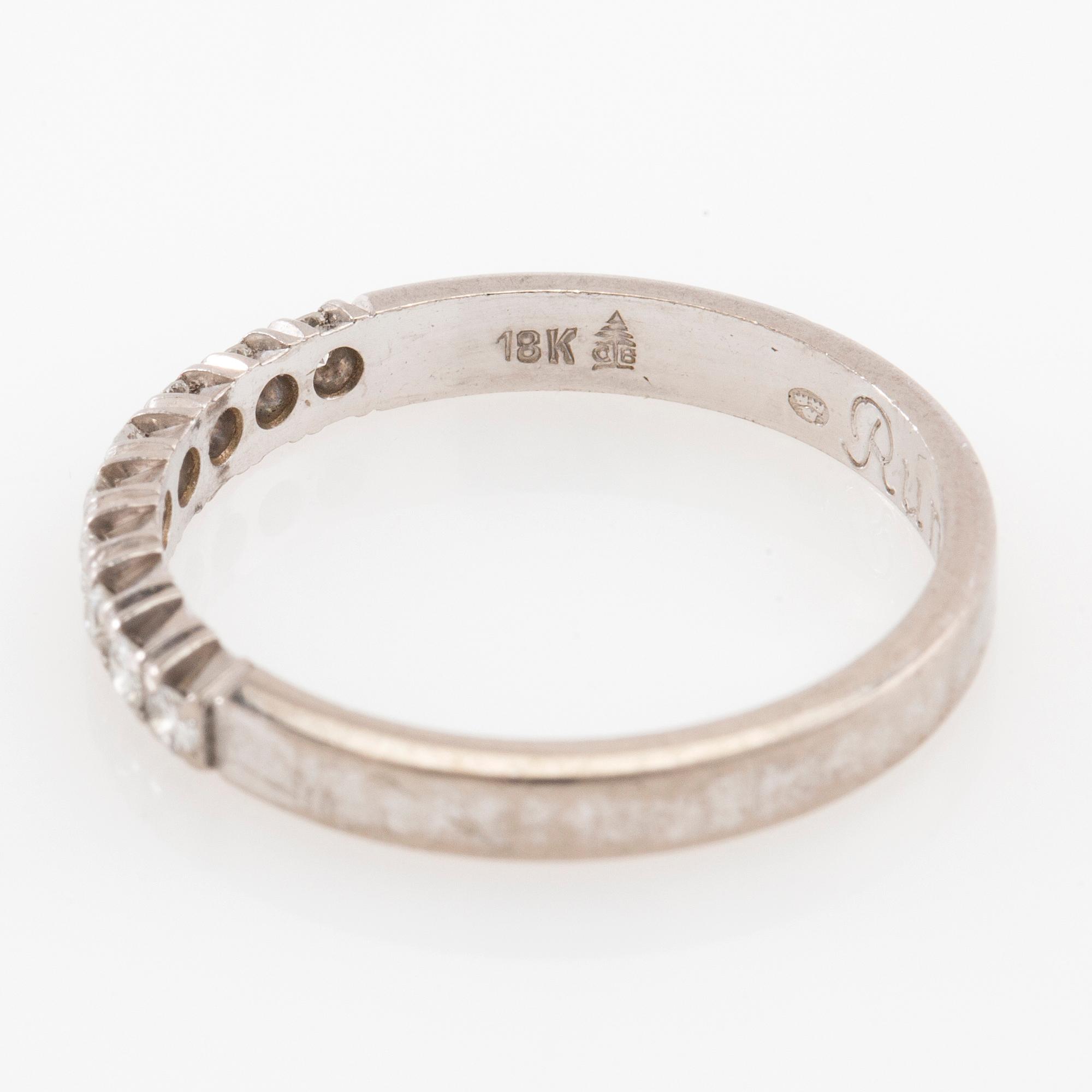 Ring with a half eternity band in 18K white gold set with round brilliant-cut diamonds.