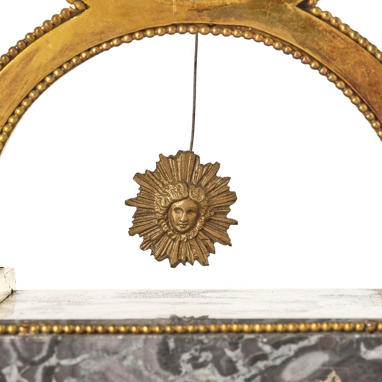 A French Louis XVI ormolu and marble lyre-shaped mantel clock, late 18th century.
