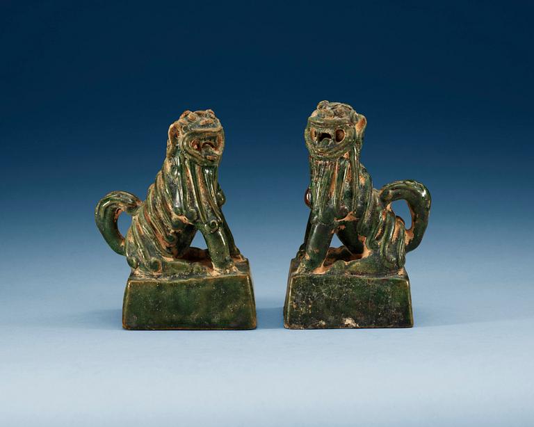 A pair of green glazed figures of 'Buddhist Lions', Ming dynasty.