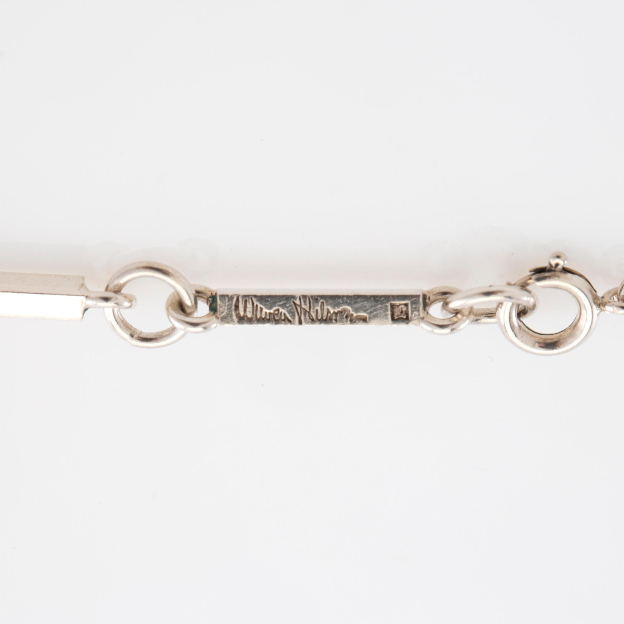 Wiwen Nilsson, Collier av silver och fasetterade bergkristaller i form av ett kors, Lund 1937.