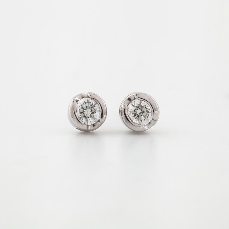 A pair of brilliant cut diamond earrings.