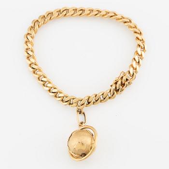 Bracelet with a charm in the shape of a globe, 18K gold, curb chain.