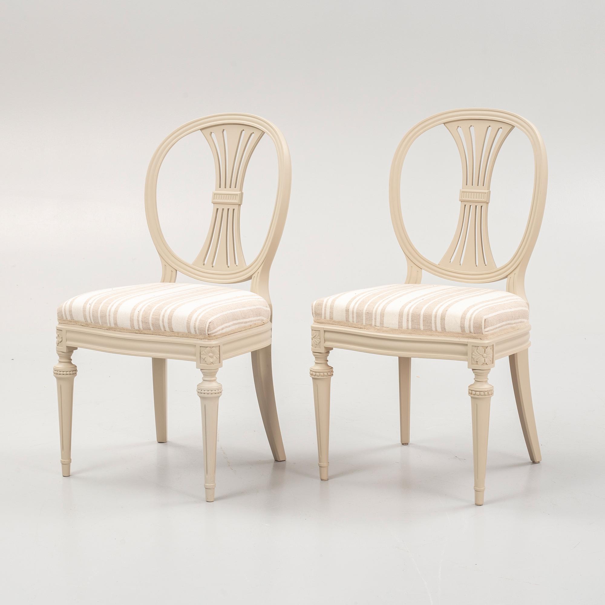 A Gustavian style dining table and eight chairs, late 20th Century.