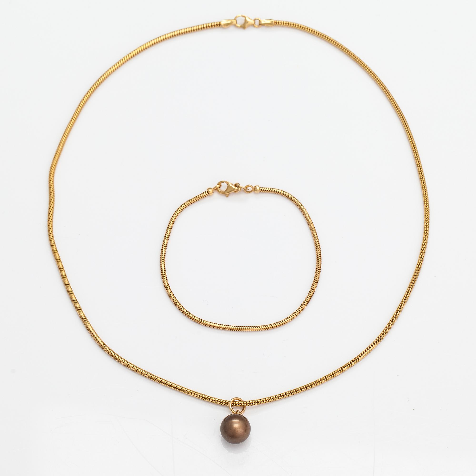 A 14K gold necklace and bracelet with a cultured pearl.
