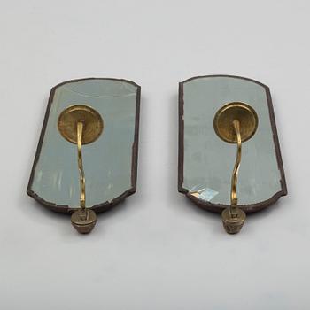 A pair of mirrors with candle sconces, partly 18th century.