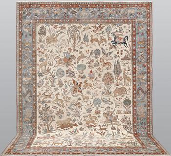 A semi-antique Ghom carpet, approx. 390 x 290 cm.