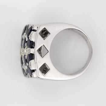 RING, 18k vitguld med briljantslipade diamanter, ca 1.20 ct samt fasettslipade blå safirer ca 5.60 ct. Vikt 18 g.