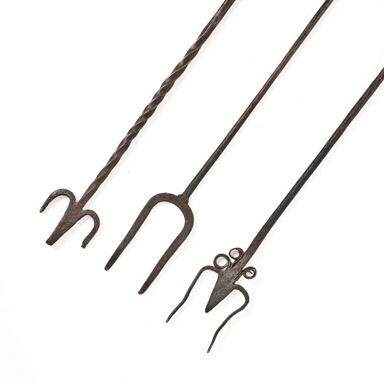 A set of three wrought iron fireplace pokers, 18th / 19th century.