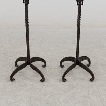 a pair of iron floor candle sticks, 20th century.