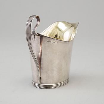 a 1824's silver creamer.