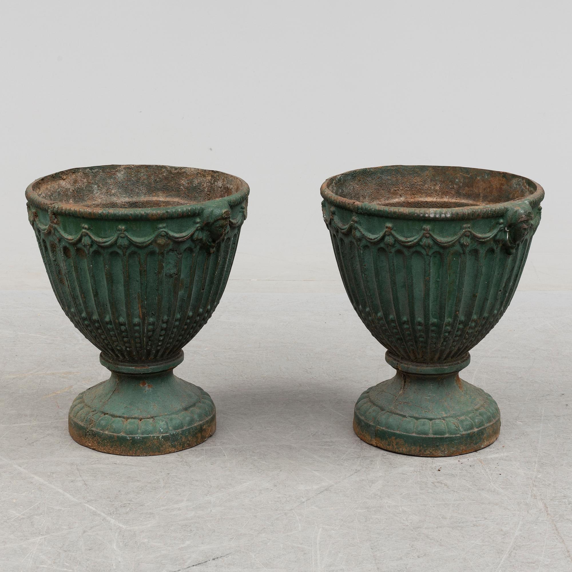 A pair of early 20th century iron garden urns.