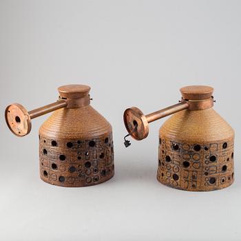 A pair of stoneware and copper wall lamps by Lisa Larson.