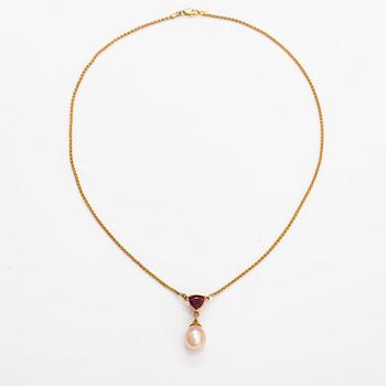 A 14K gold necklace with a tourmaline and cultured pearl.