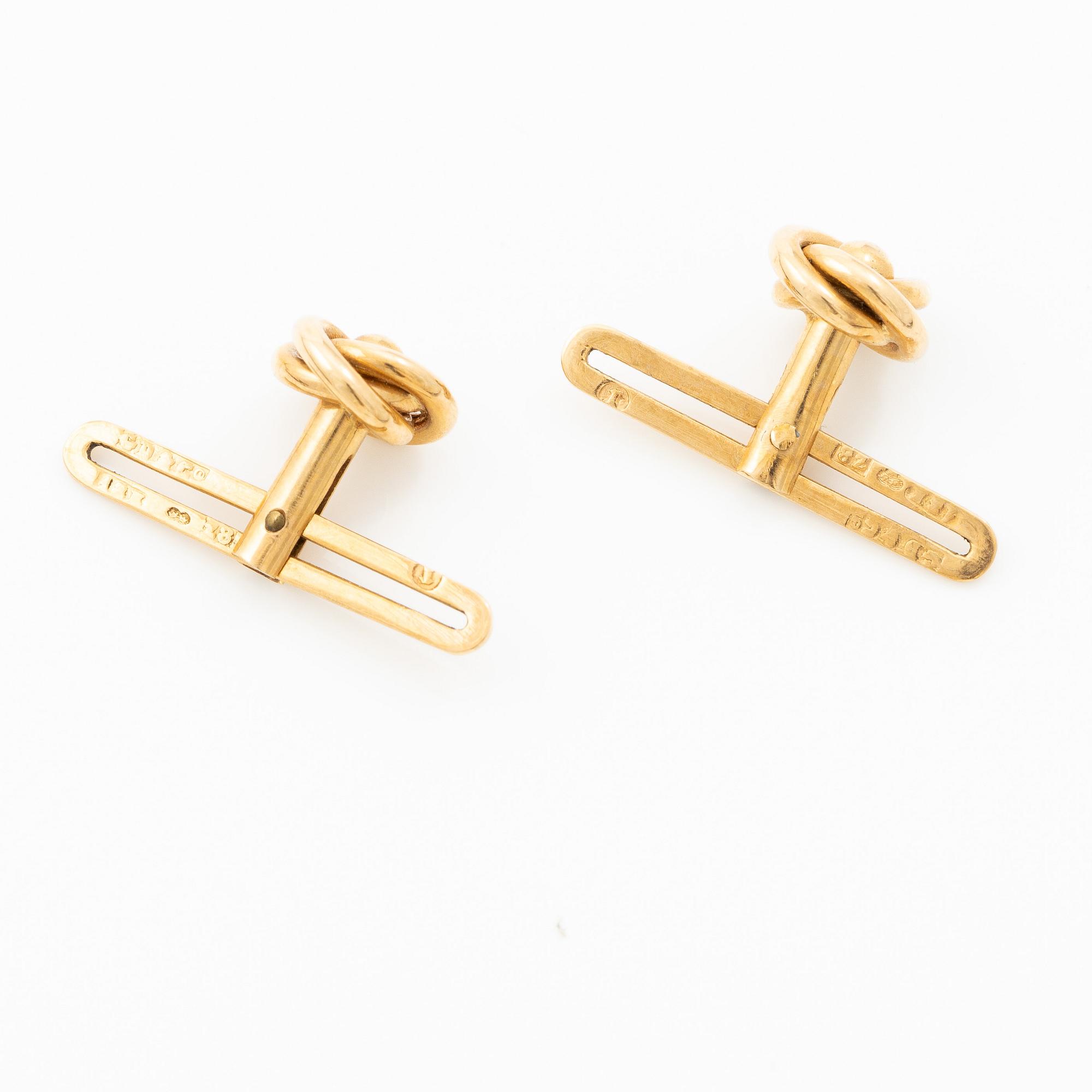 Shirt buttons, a pair and two cravat pins, 18K gold, with synthetic red stone and pearl.