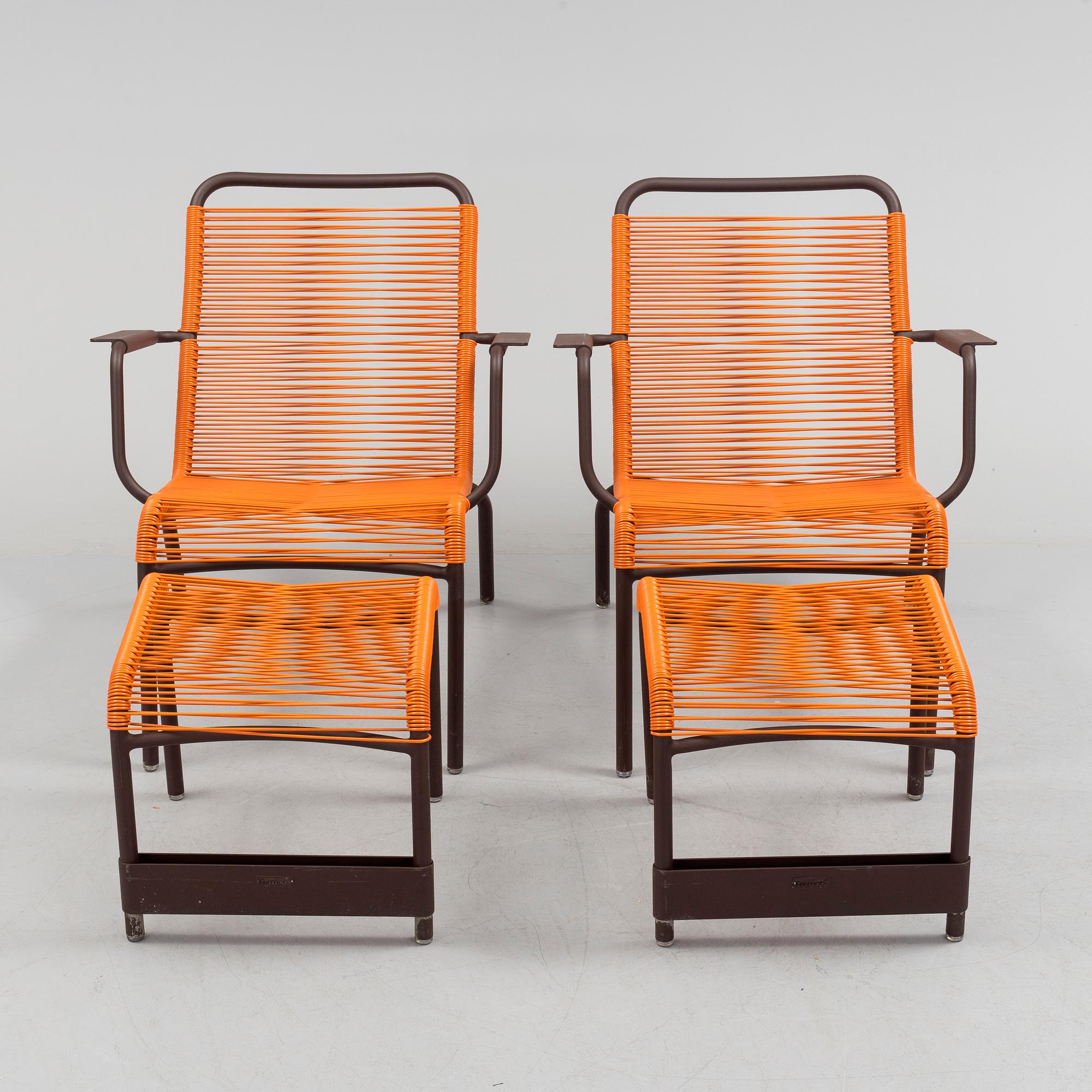 a pair of FRÉDÉRIC SOFIA "Saint Tropez" lounge chairs with footstools, by Fermob.