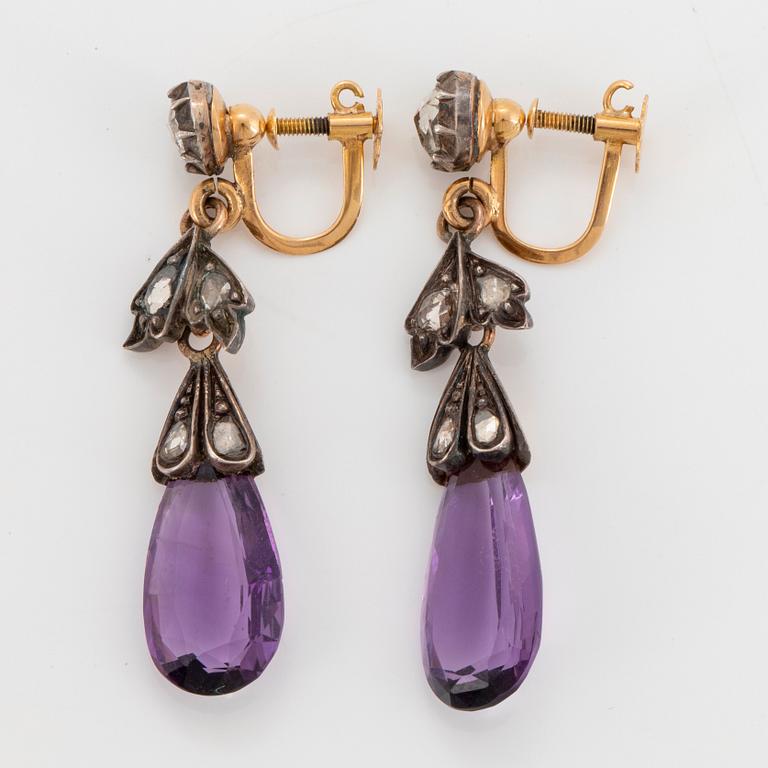 A pair of 14K gold and silver earrings set with faceted amethysts and rose-cut diamonds.