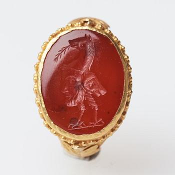 A possibly Etruscan gold and carnelian signet ring.