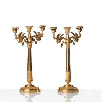 A pair of Empire early 19th century gilt bronze three-light candelabra.