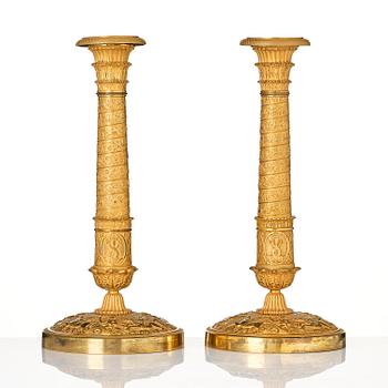 A pair of French Empire ormolu candlesticks, Paris, early 19th century.