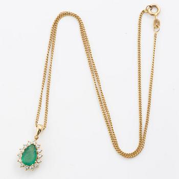 Gold necklace with a drop-shaped emerald and octagon-cut diamonds.