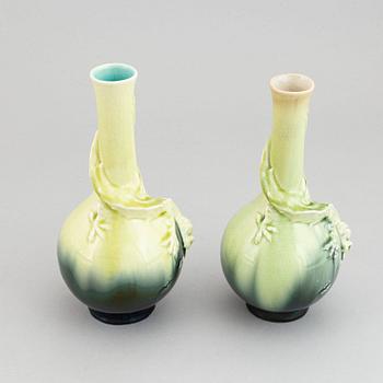 A pair of green glazed ceramic vases decorated with a lizard and an insect, Rörstrand, Sweden. Early 20th century.